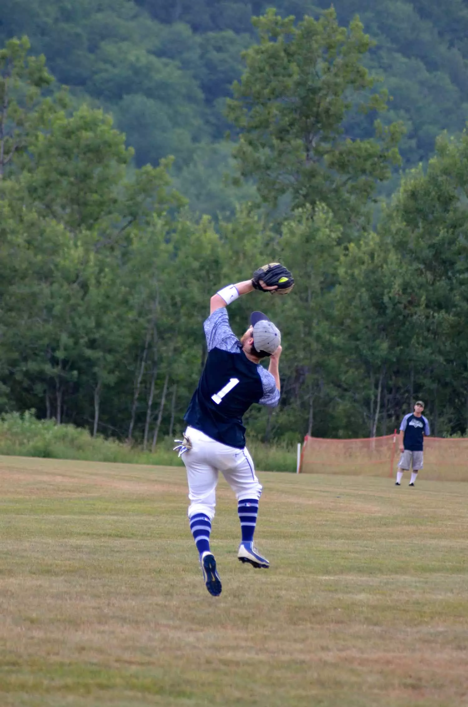 By Robin Alberti Donning No. 1, Clearly Moguls’ right fielder Tucker Zink jumps for a catch, while Brandon Remmick looks on. 